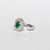 Anello in Oro Bianco 18 kt con Smeraldo Centrale e Doppio giro di Diamanti