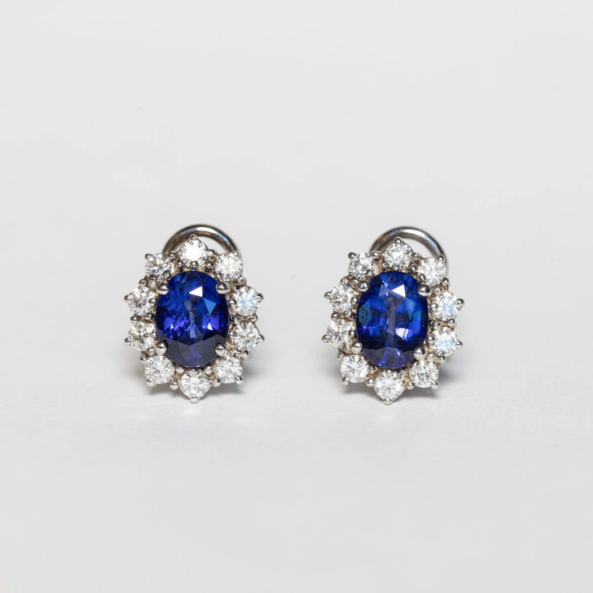 18kt white gold earrings with sapphires and diamond surround