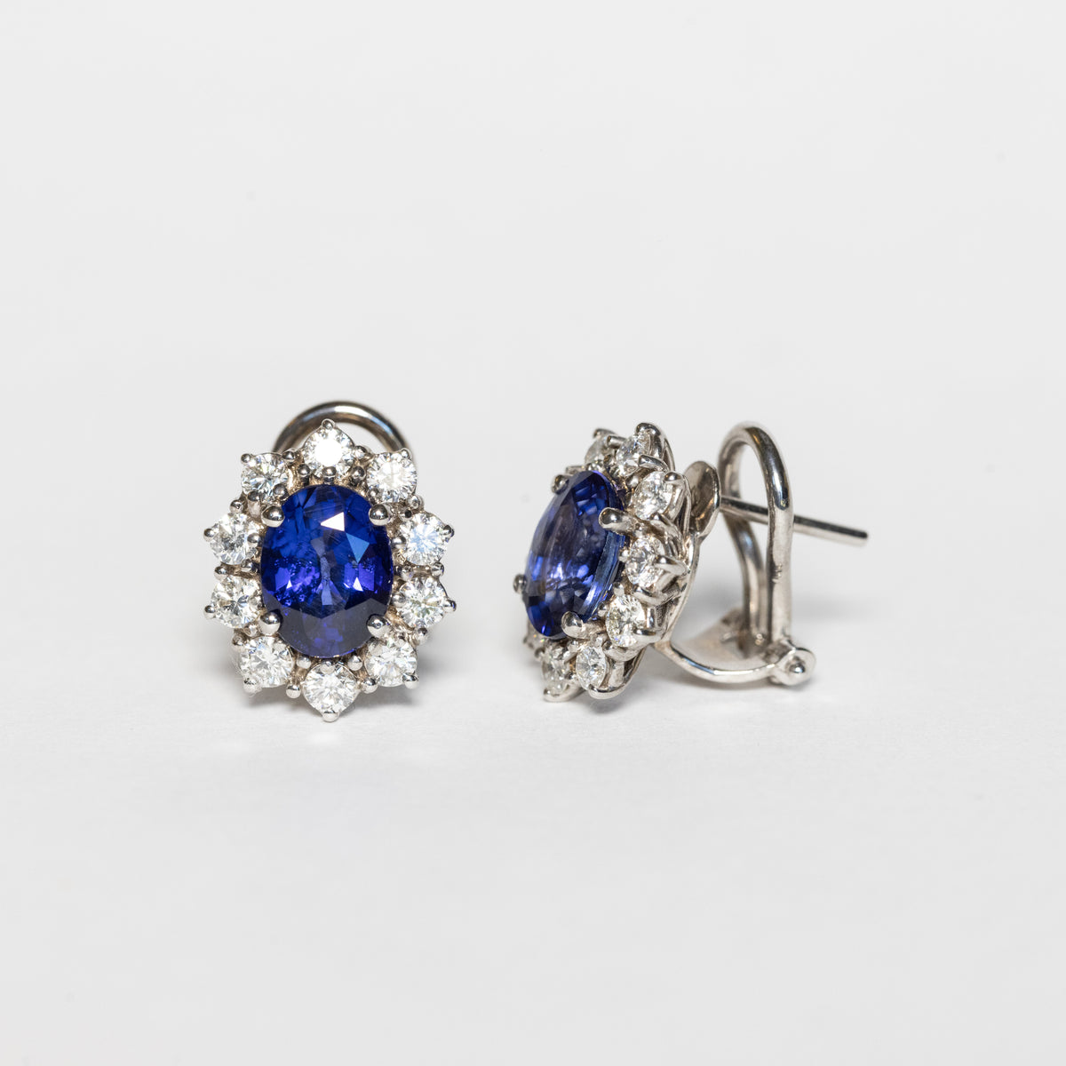 18kt white gold earrings with sapphires and diamond surround
