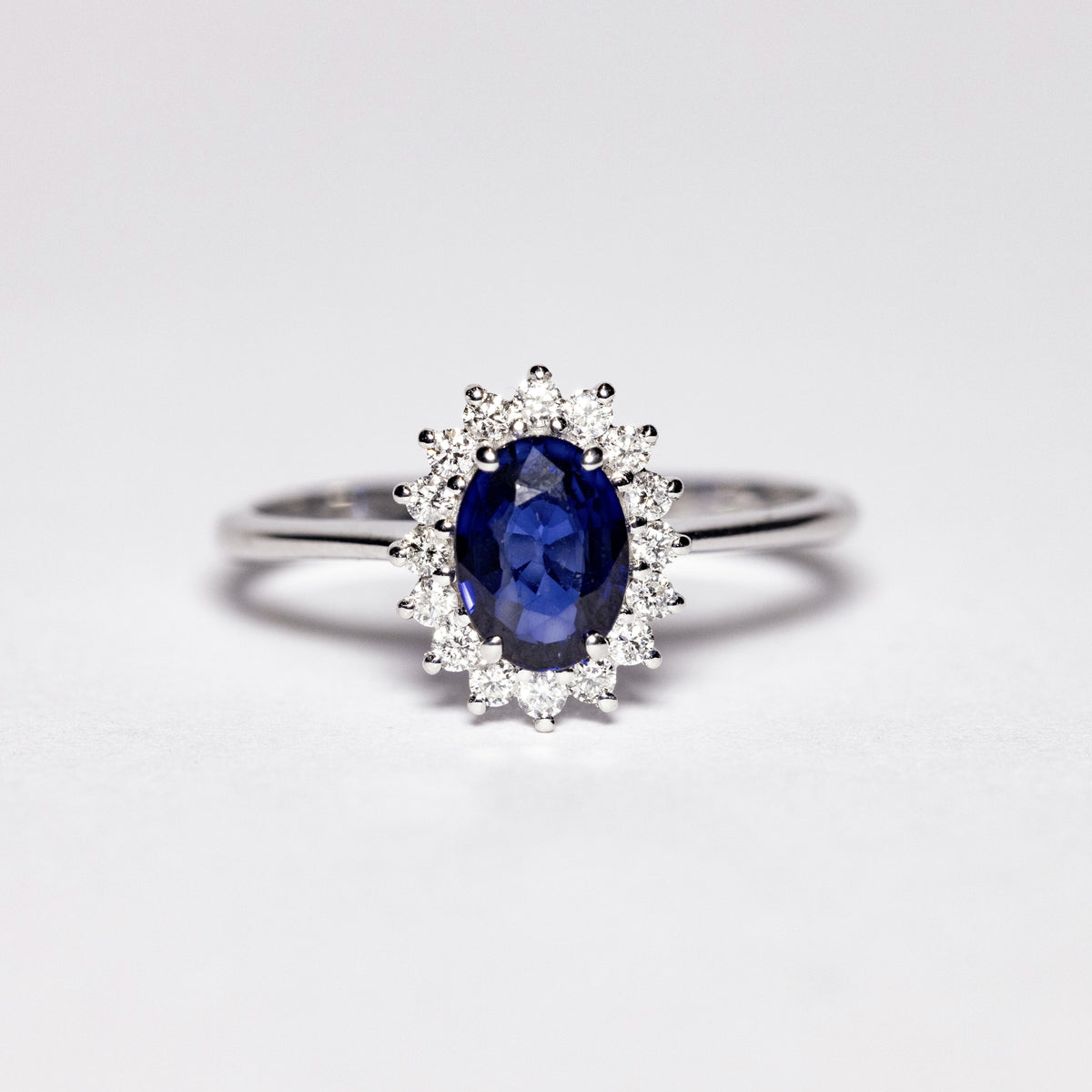 18kt White Gold Ring with Oval Sapphire and Diamond Surround