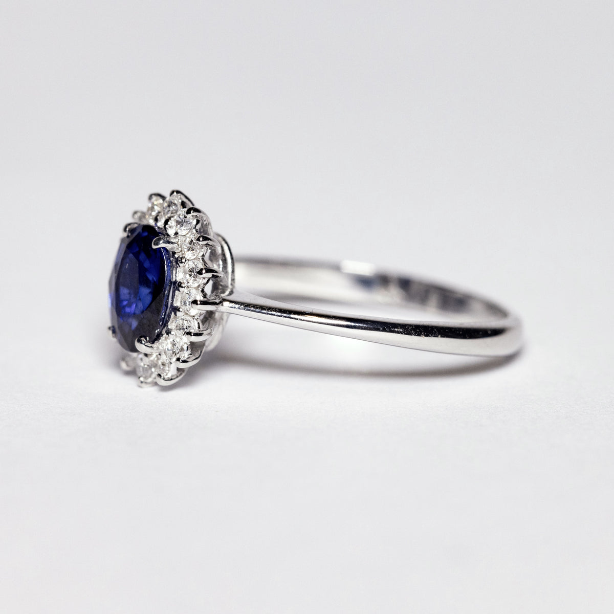 18kt White Gold Ring with Oval Sapphire and Diamond Surround