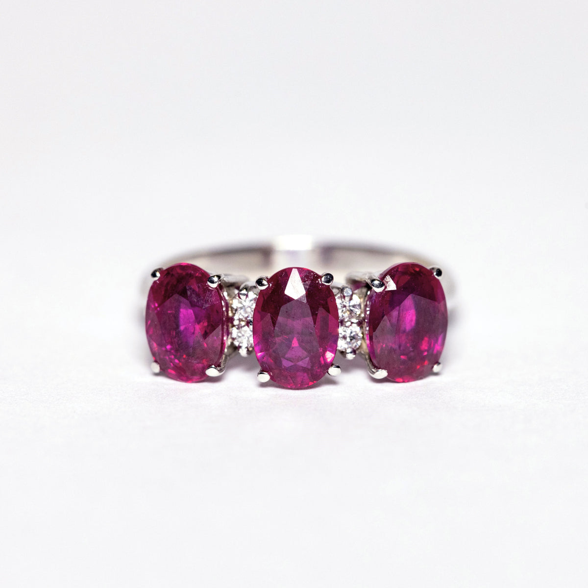 18kt White Gold Trilogy Ring with Oval Cut Rubies and Diamonds