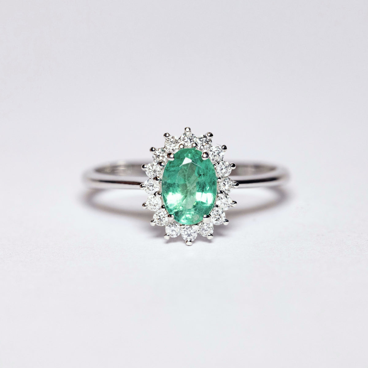 18kt White Gold Ring with Oval Cut Emerald and Diamond Surround