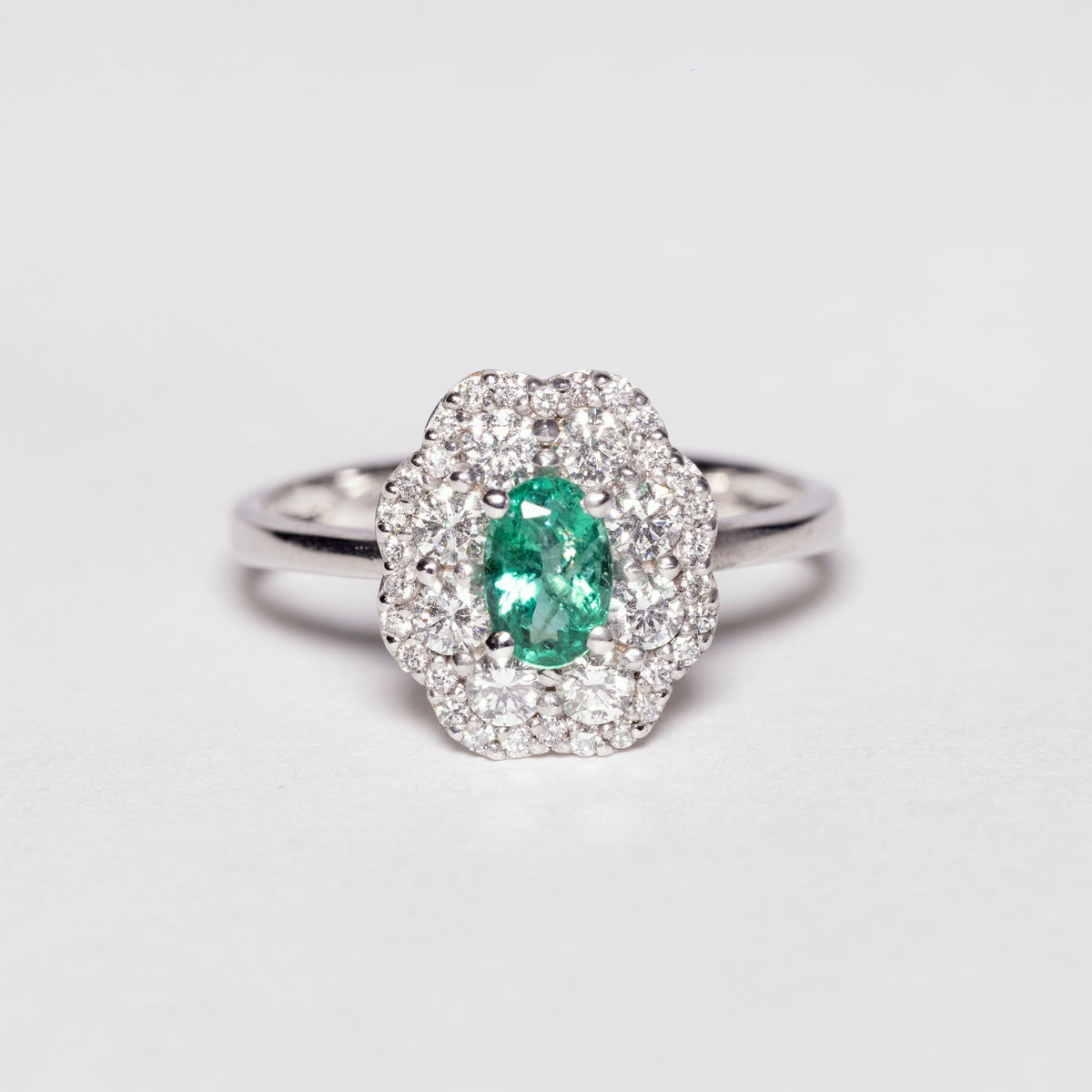 18 KT White Gold Flower Fantasy Ring With Central Emerald and Double Row of Diamonds