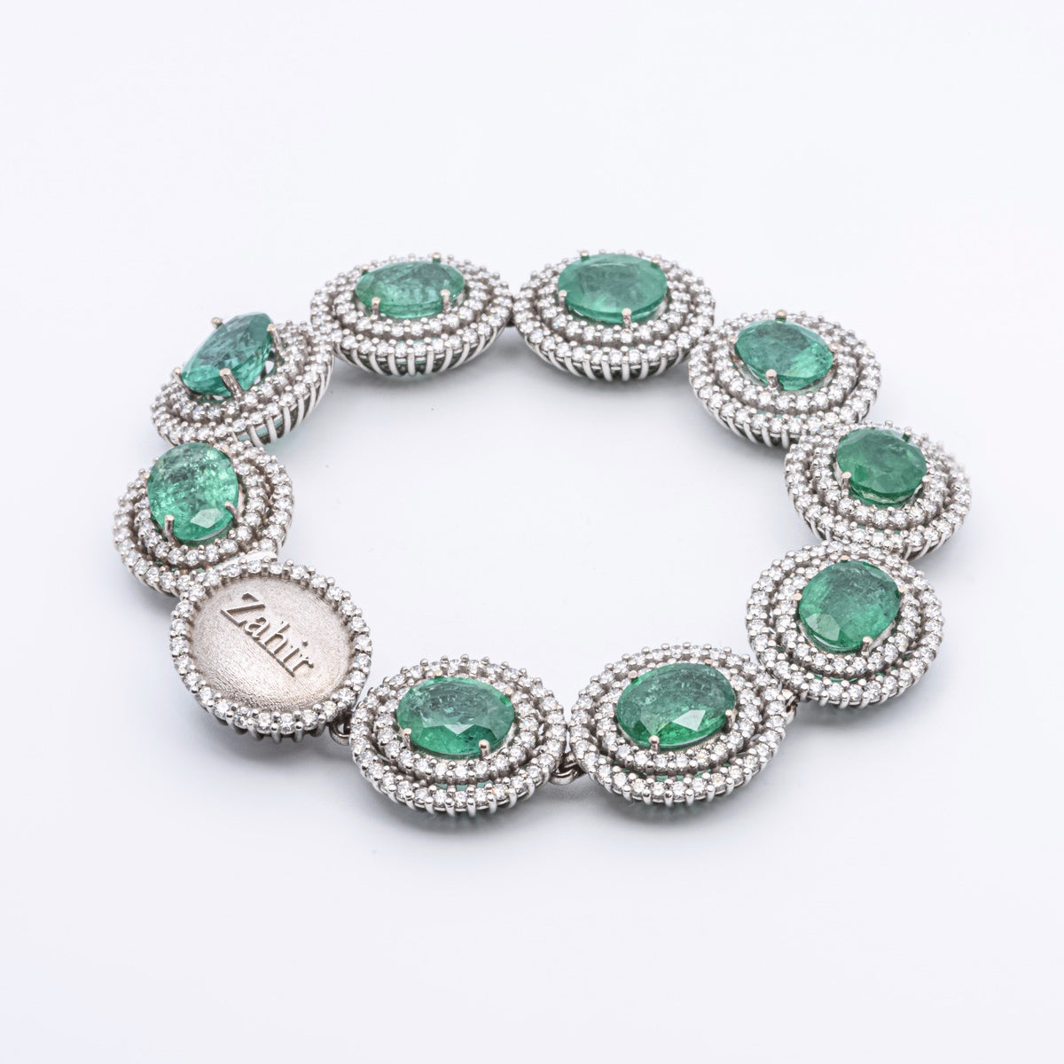 Zahir™ Luxury Bracelet with Emeralds and Diamonds in 18 kt White Gold