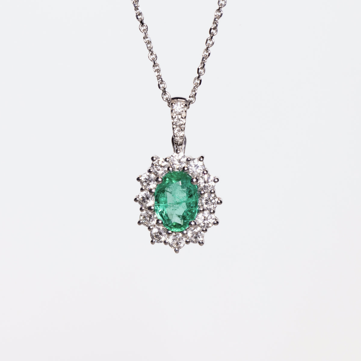 Central Emerald Pendant Surrounded by Diamonds in 18kt White Gold