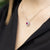 Collana in Oro Bianco 18 Kt Forma a Cuore Pave' con Doppio Giro di Diamanti e Rubino Centrale