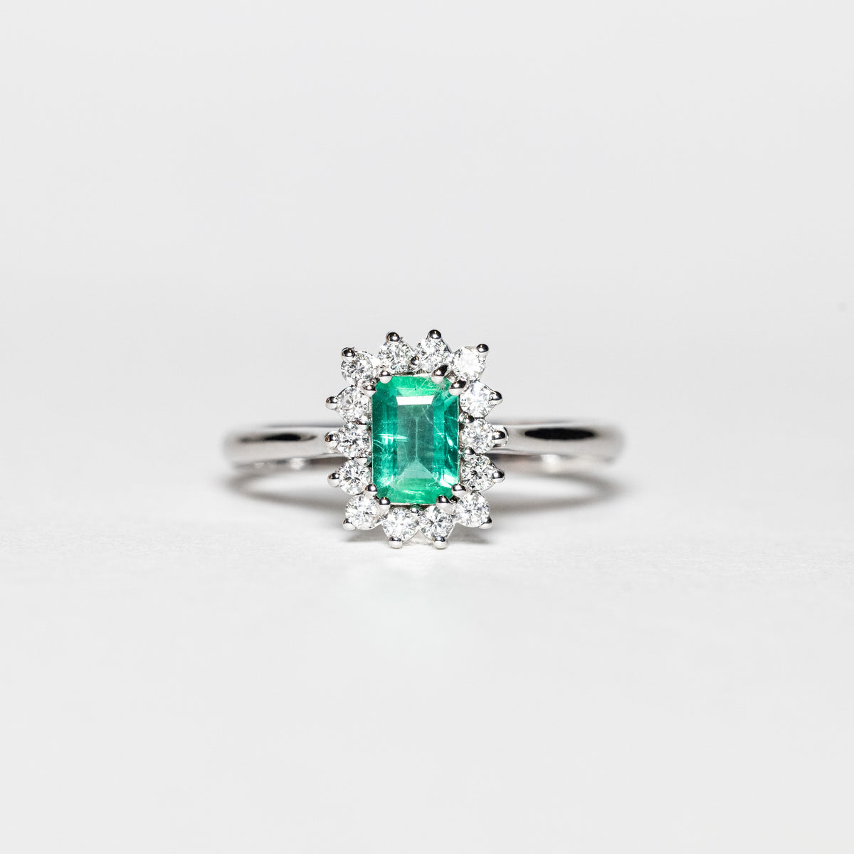 18Kt White Gold Ring With Emerald Cut Emerald Surrounded By Diamonds