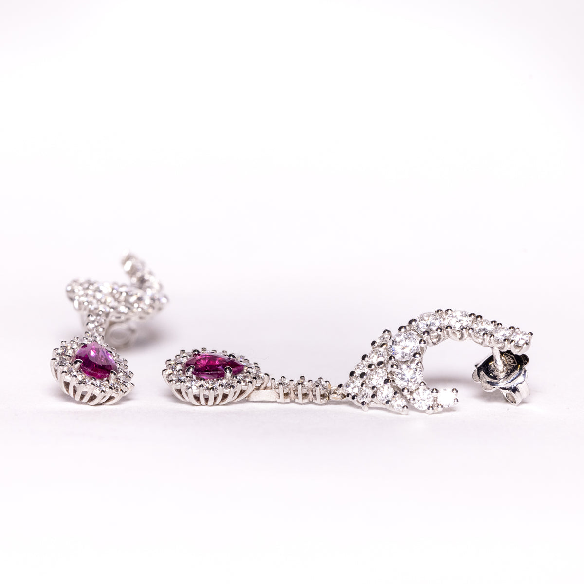 18kt white gold earrings with drop-shaped rubies surrounded by diamonds