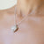 Collana Pendente forma Cuore in oro bianco 18kt in pavè di Diamanti e fantasie a grappolo di smeraldi, zaffiri, rubini e diamanti