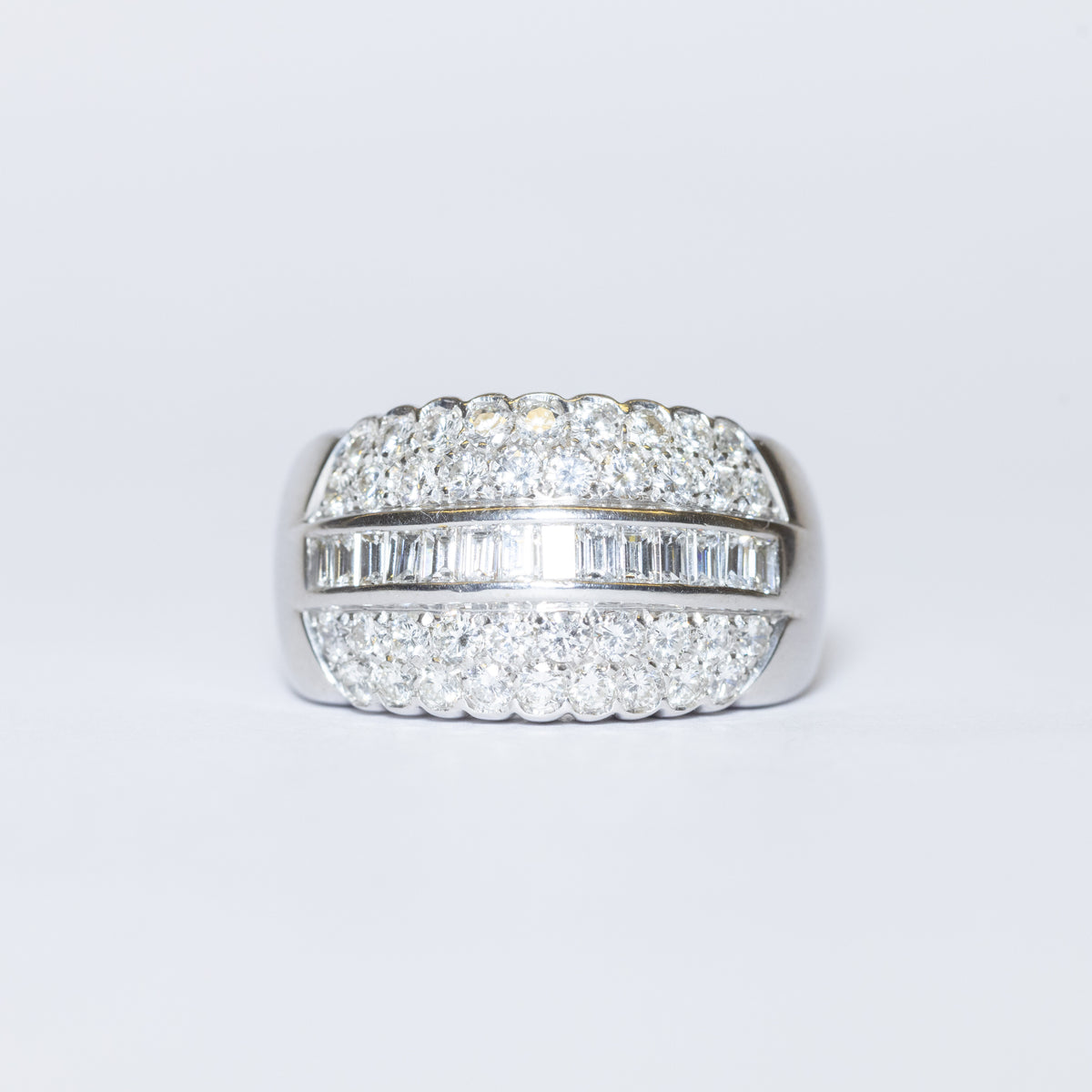 18KT White Gold Band Ring with Baguette Cut Central Diamonds and Round Brilliant Cut Side Diamonds