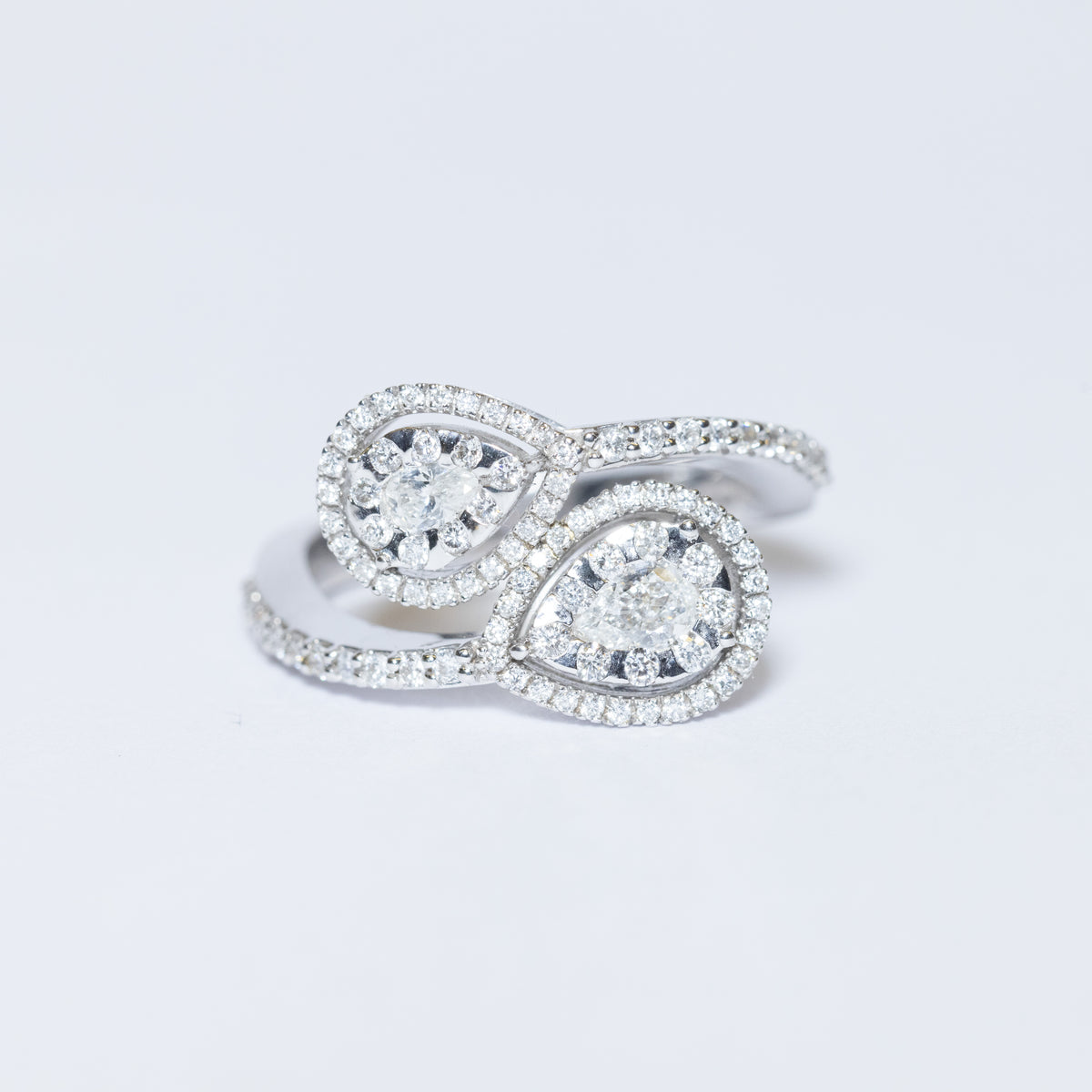18KT White Gold Drop-Shaped Contrariè Ring with Round Brilliant Cut Diamonds in Pavé