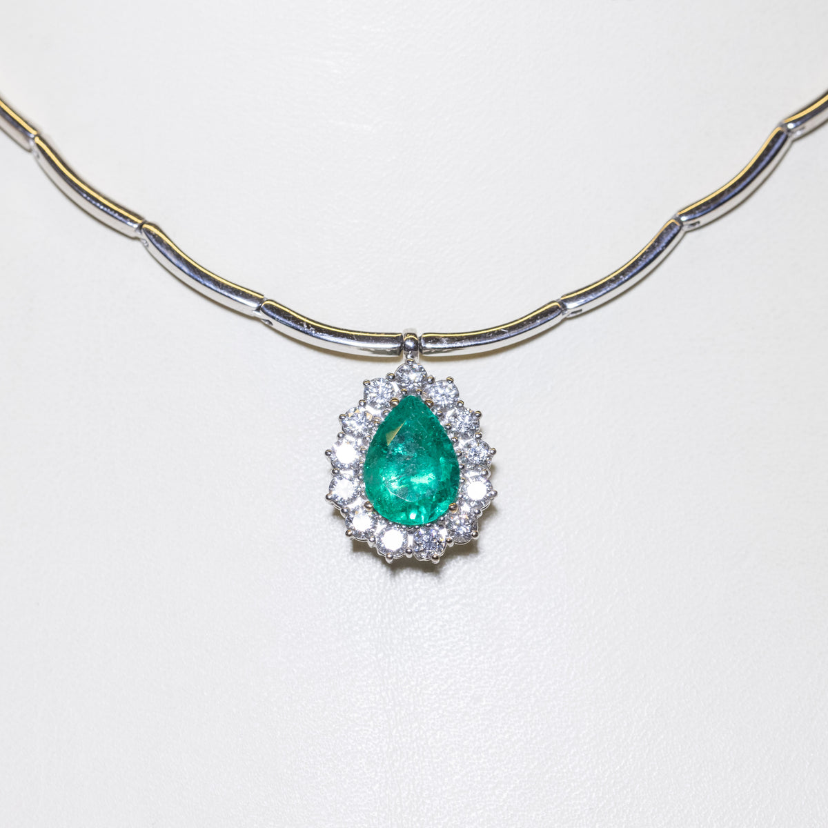 18kt White Gold Emerald Drop Pendant Necklace with Diamond Surround