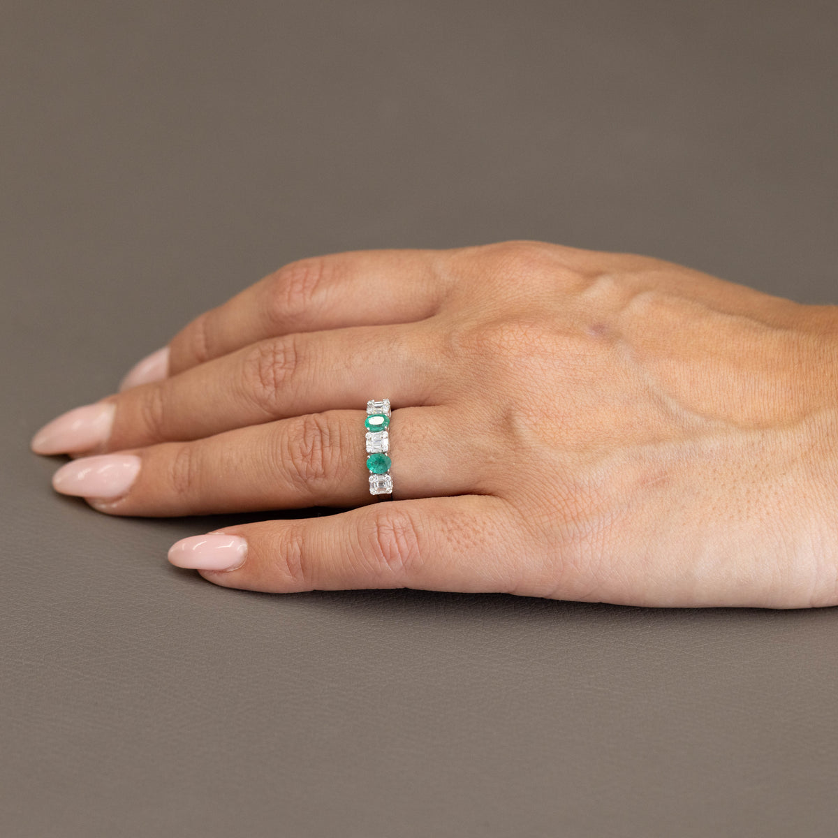 18kt White Gold Ring with Oval Cut Emeralds and Baguette Cut Diamonds