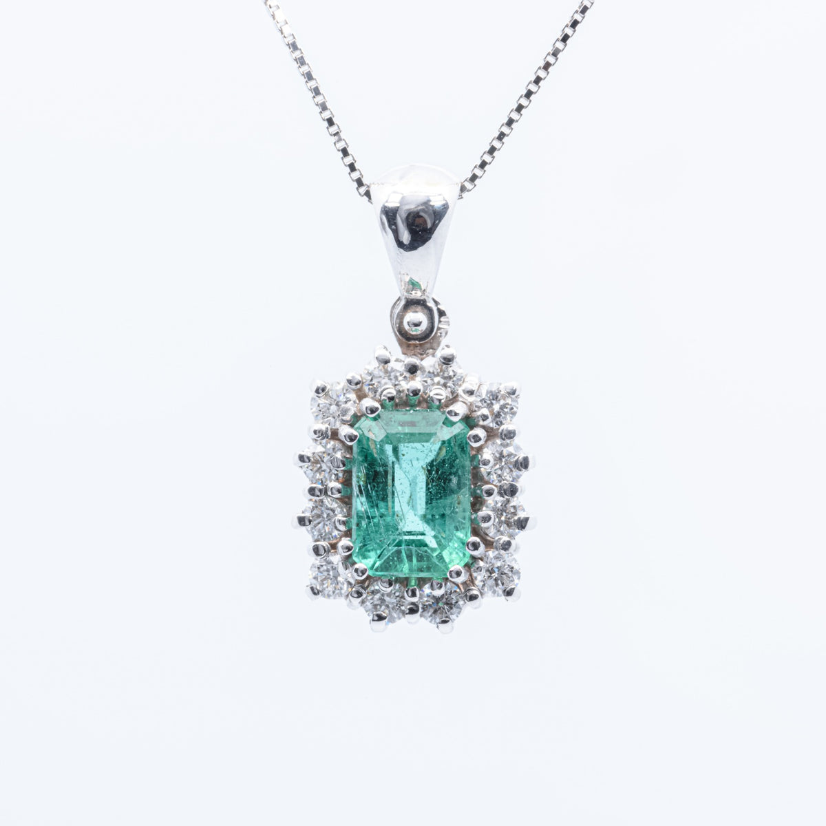 Central Emerald Pendant Surrounded by Diamonds in 18kt White Gold