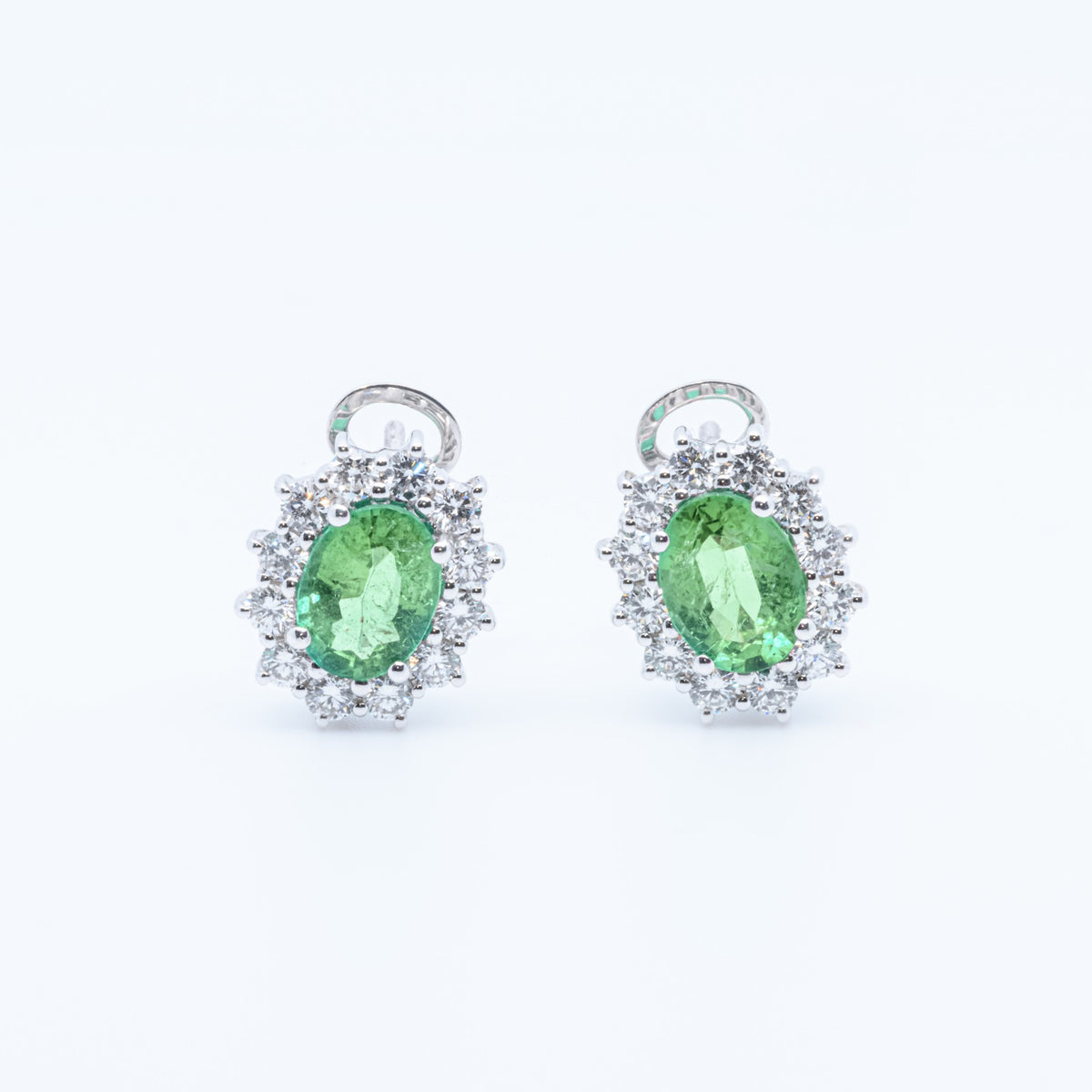 18kt white gold earrings with 1.10kt diamonds and 2.12kt emeralds