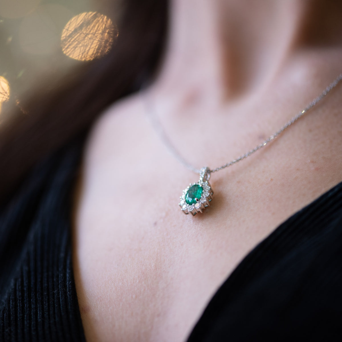 Central Emerald Pendant Surrounded by Diamonds in 18kt White Gold
